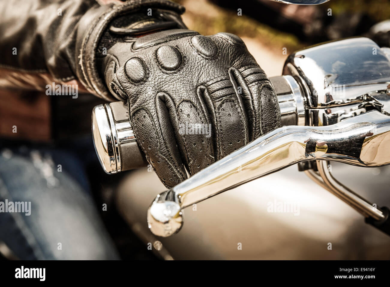 Human hand in a Motorcycle Racing Gloves holds a motorcycle throttle control. Hand protection from falls and accidents. Stock Photo