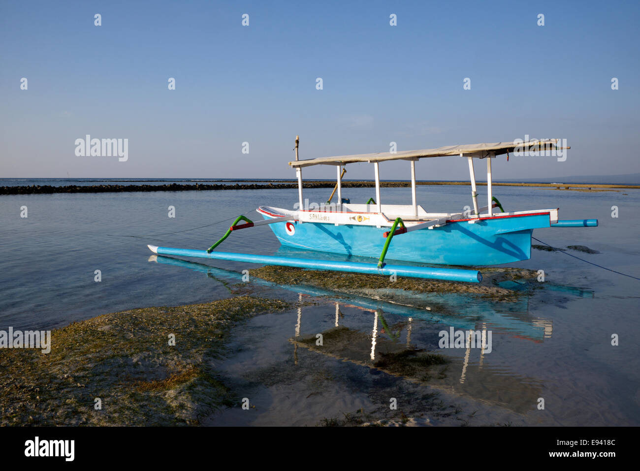 Outrigger boat at low tide Gili Air Lombok Indonesia Stock Photo
