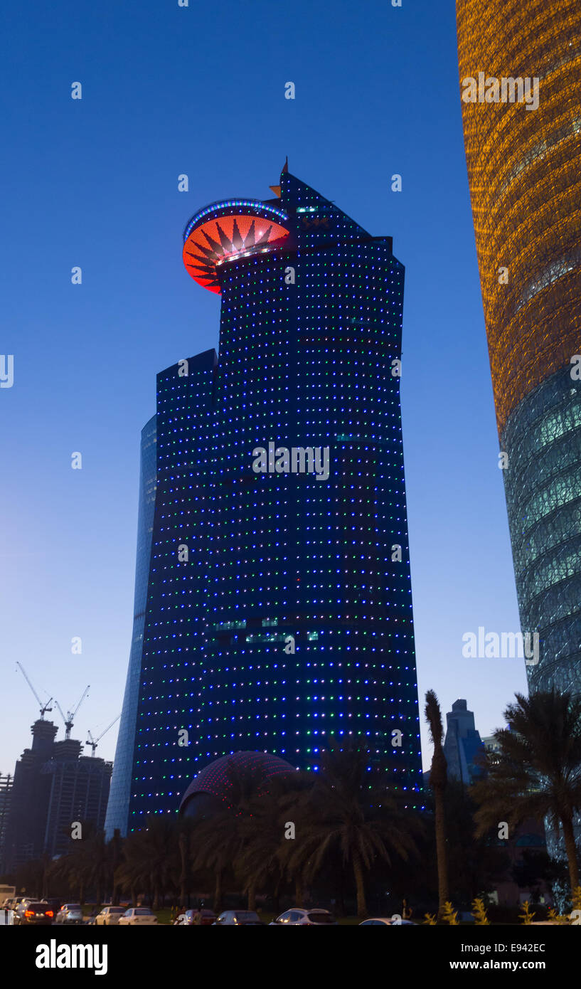 Towers lit up at sunset in the Qatari capital, Doha. Stock Photo