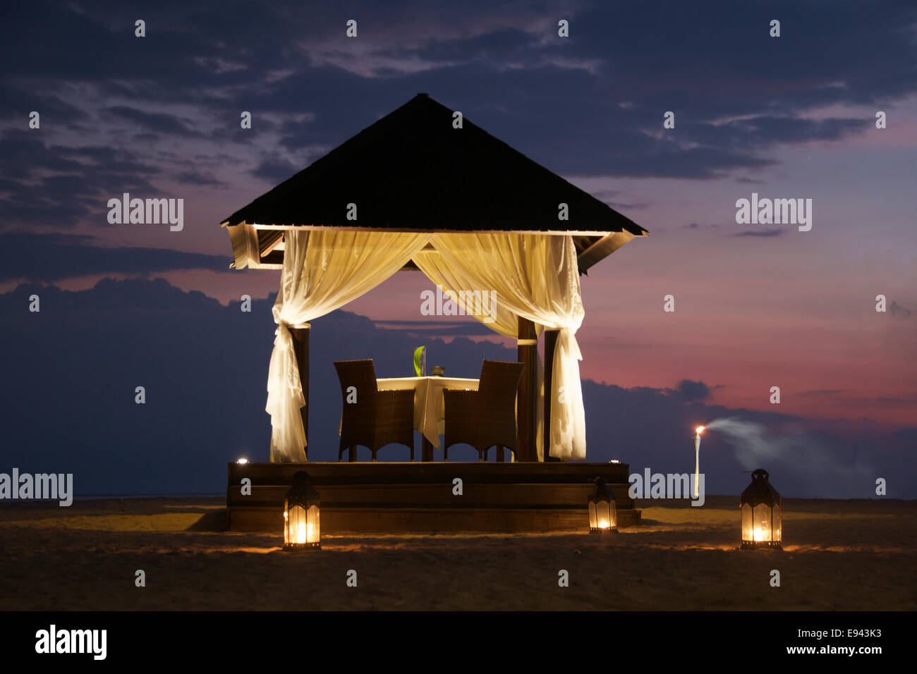 Lit romantic setting a supper table set for two Gili Trawangan Lombok Indonesia Stock Photo