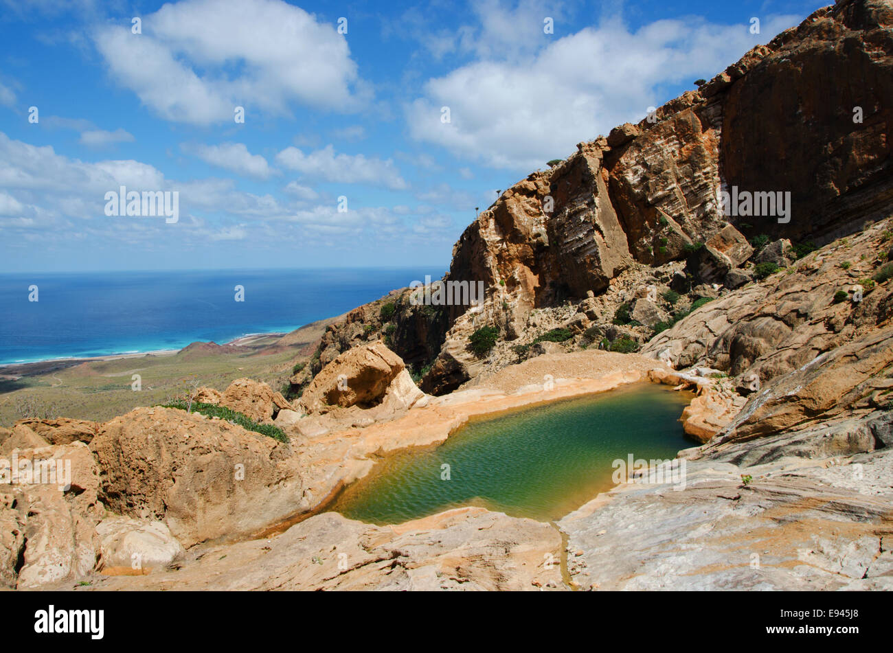 Socotra, Yemen: breathtaking overview from Homhil Plateau with the wadi, natural pool of freshwater, and the Arabian Sea Stock Photo