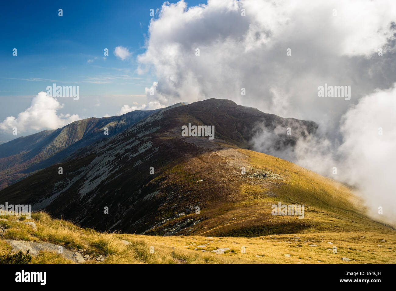 Shadows and lights on a wide mountain ridge in the italian western Alps. Stock Photo