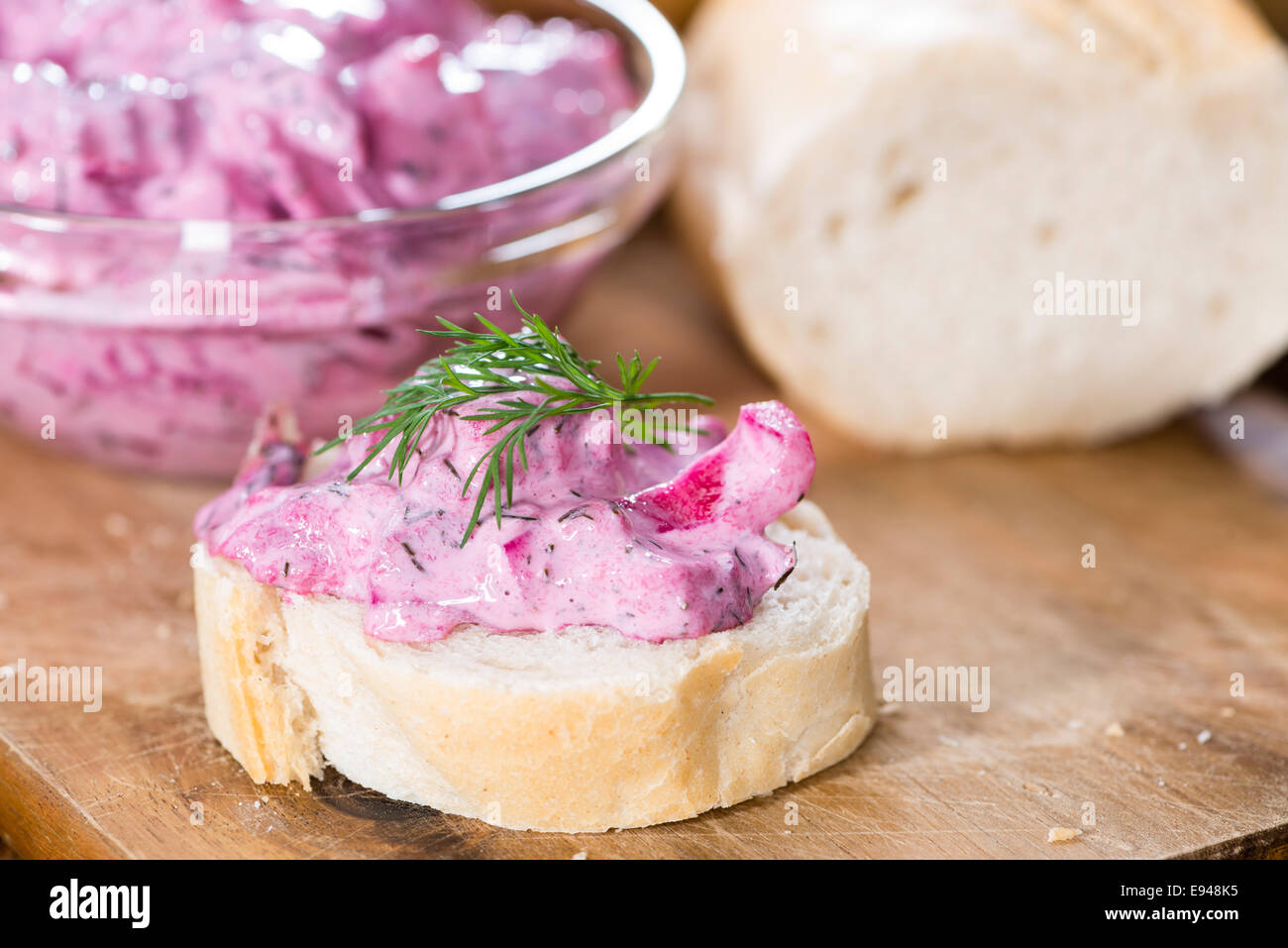 Portion of homemade Herring Salad (with beet) on wooden background Stock Photo
