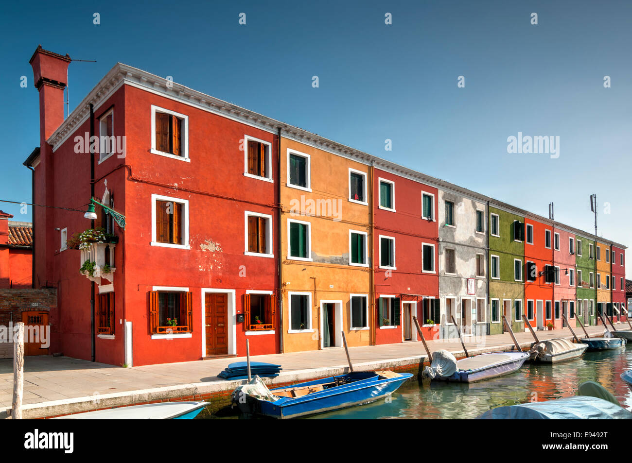 Colorful houses with boats on canal on Burano Island in Venice, Italy Stock Photo