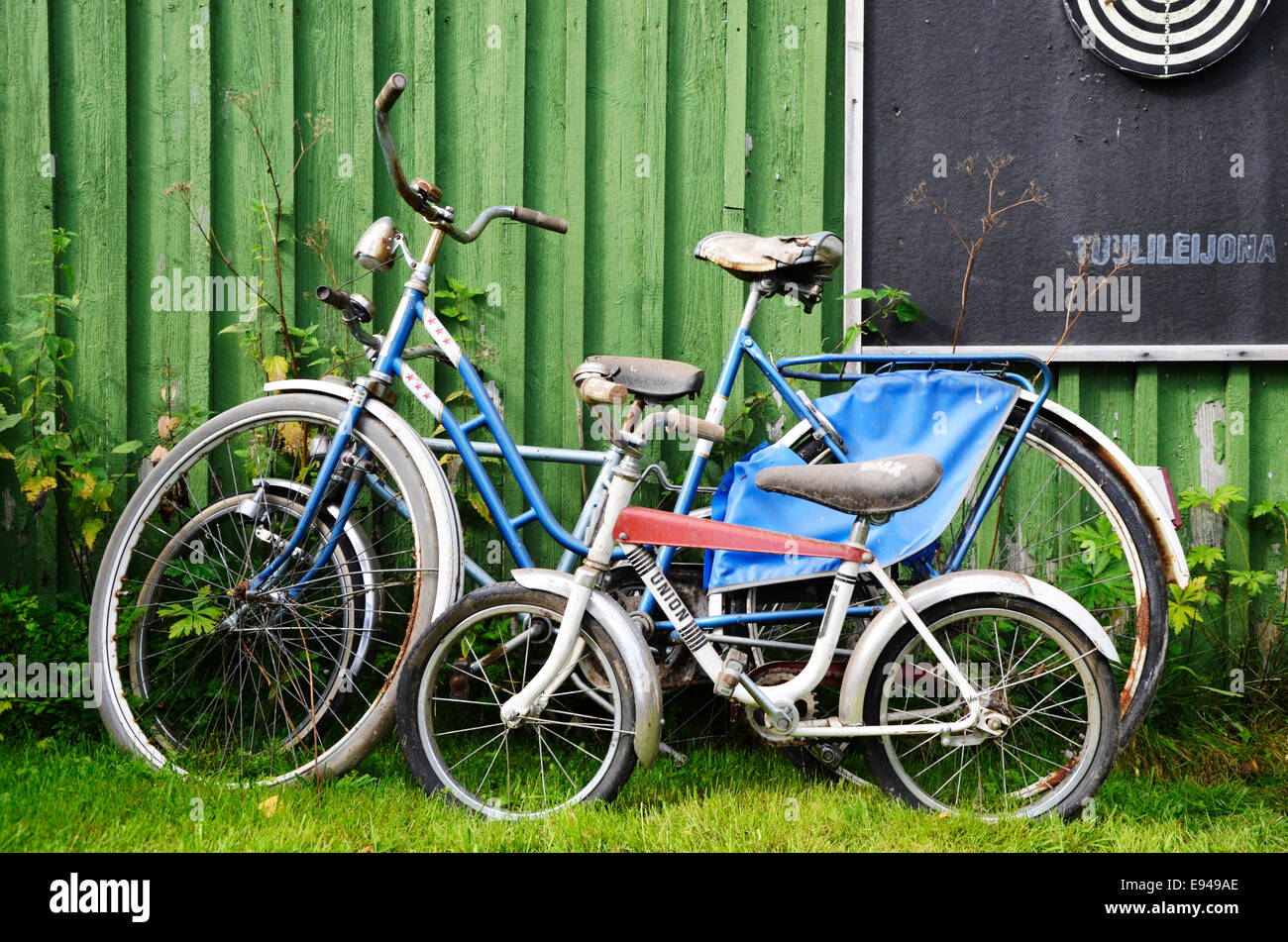 Old bicycles leaning against a barn Stock Photo
