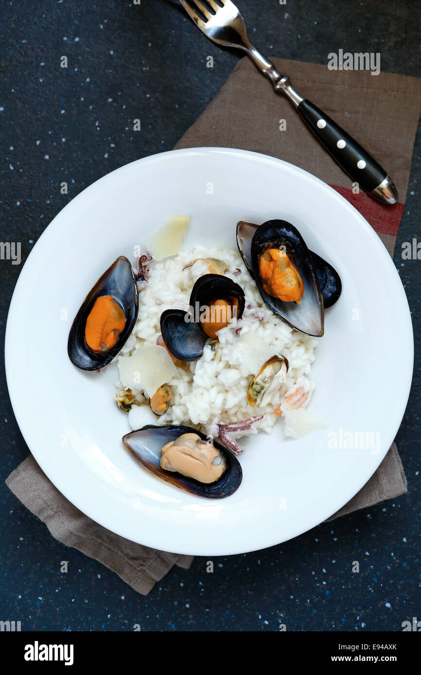Italian mussels with rice in white plate, top view Stock Photo Alamy