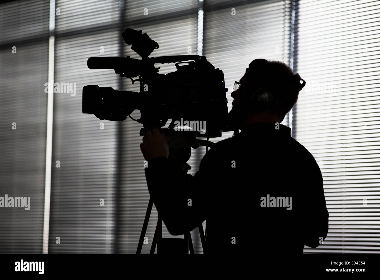 A video camera operator at a conference in the UK Stock Photo