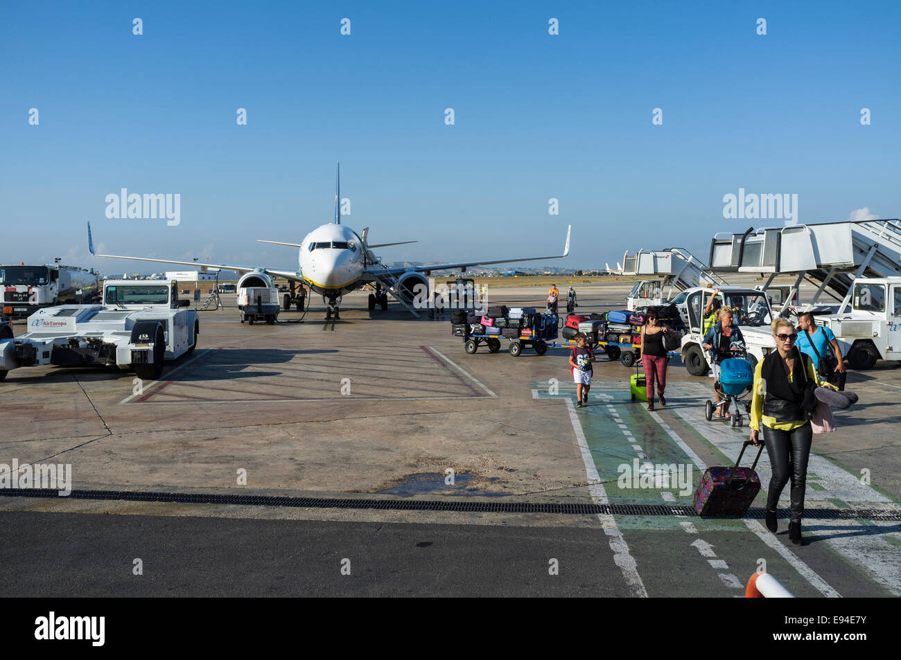 Passengers disembark by stairs from a Ryanair Boeing 737-800 at Valencia airport, Spain. Stock Photo