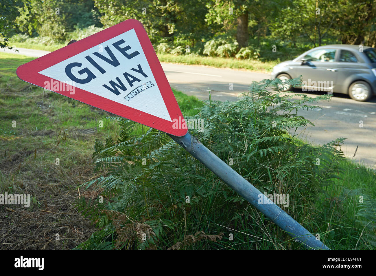 Give Way road sign laying on its side Stock Photo