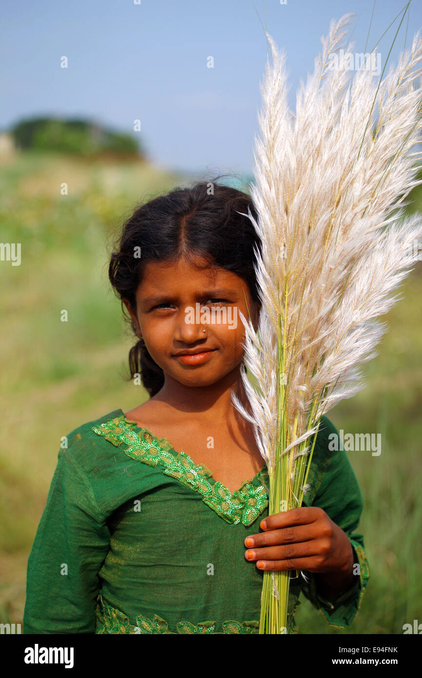 Sept. 7, 2012 - A smiley girl with catkin/kash flowers © Zakir Hossain Chowdhury/ZUMA Wire/Alamy Live News Stock Photo