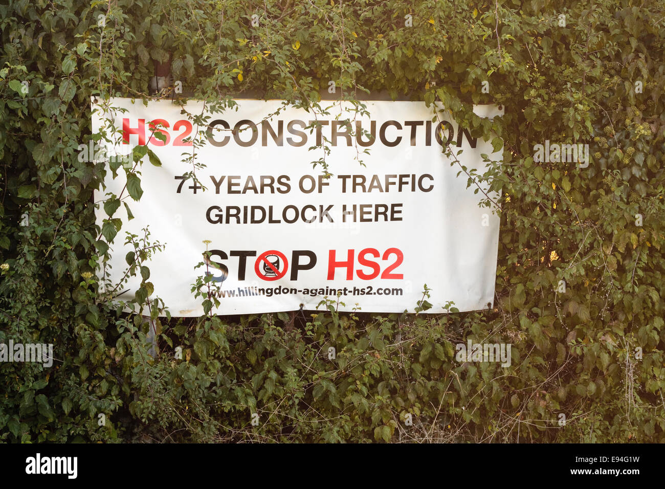 An HS2 protest banner by the 'Stop HS2' movement attached to a hedgerow Stock Photo
