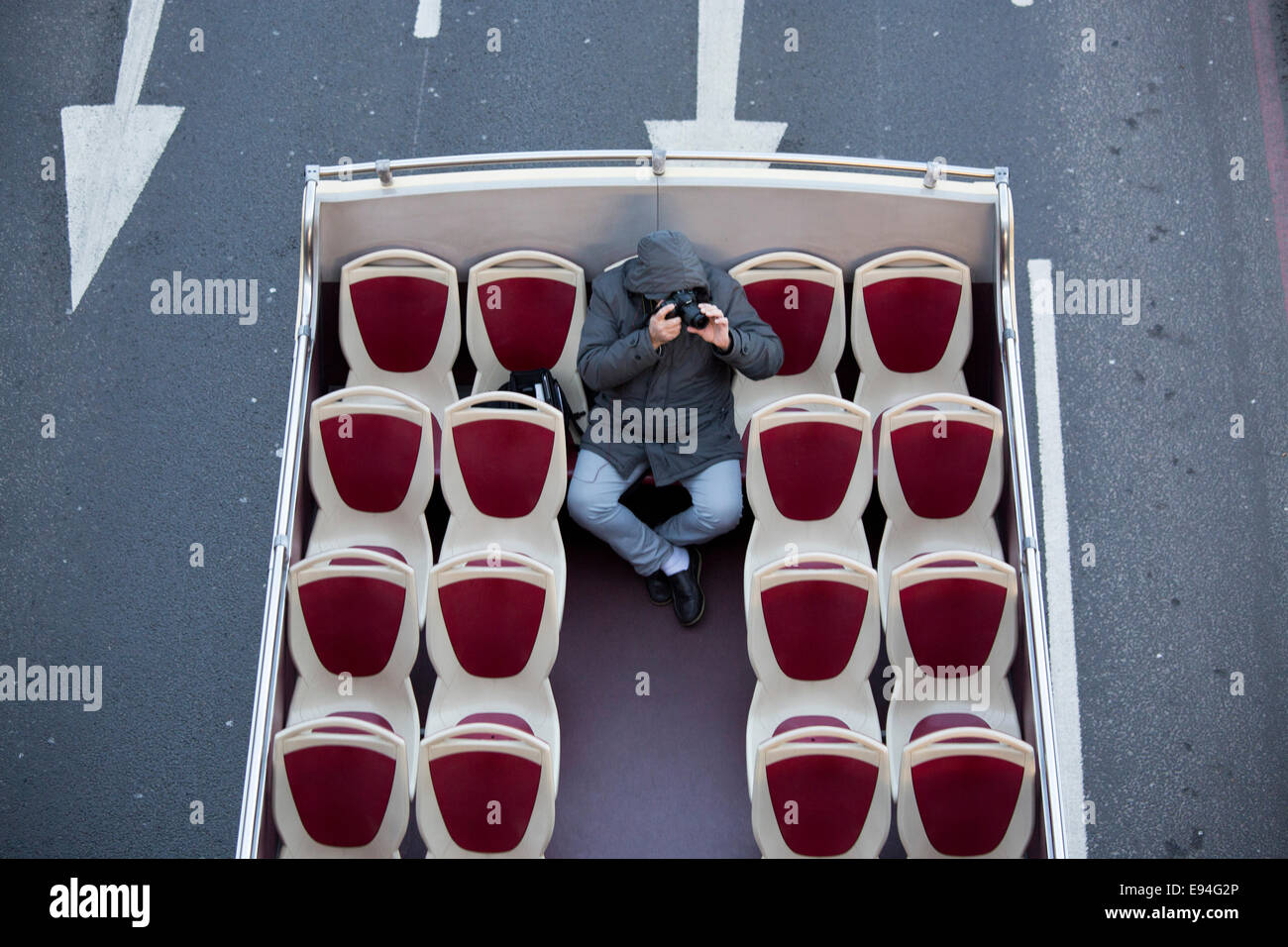 Man on open deck bus taking photographs camera Stock Photo