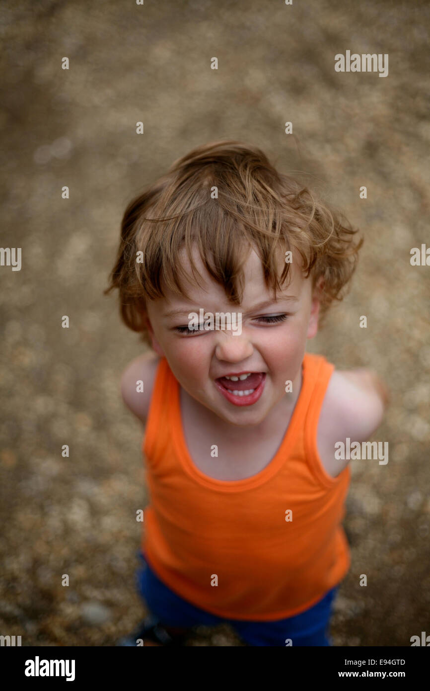 cheeky little boy laughing at camera Stock Photo