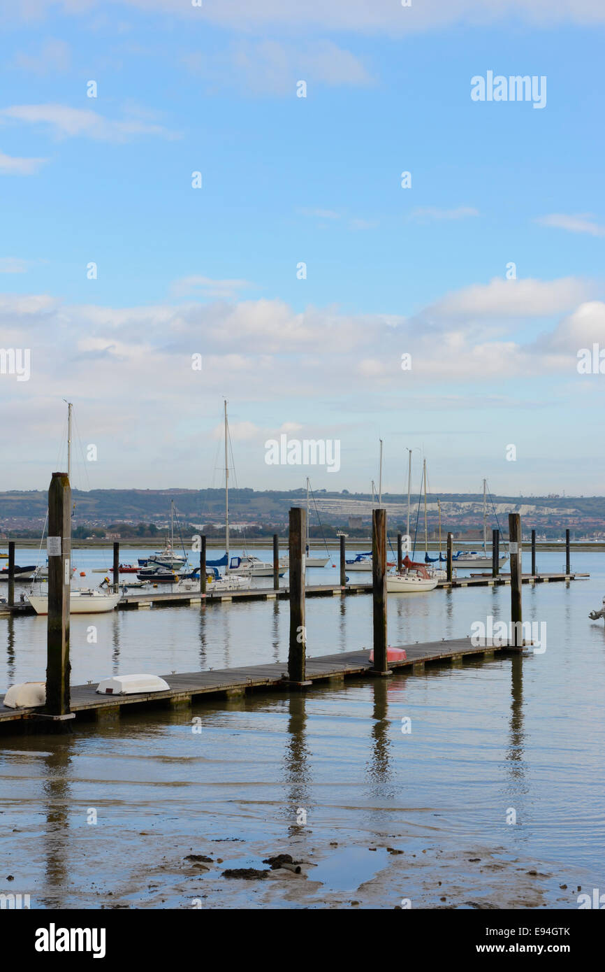 A still morning scene of moored yachts and motorboats in Portsmouth Harbour, viewed from Hardway in Gosport Stock Photo