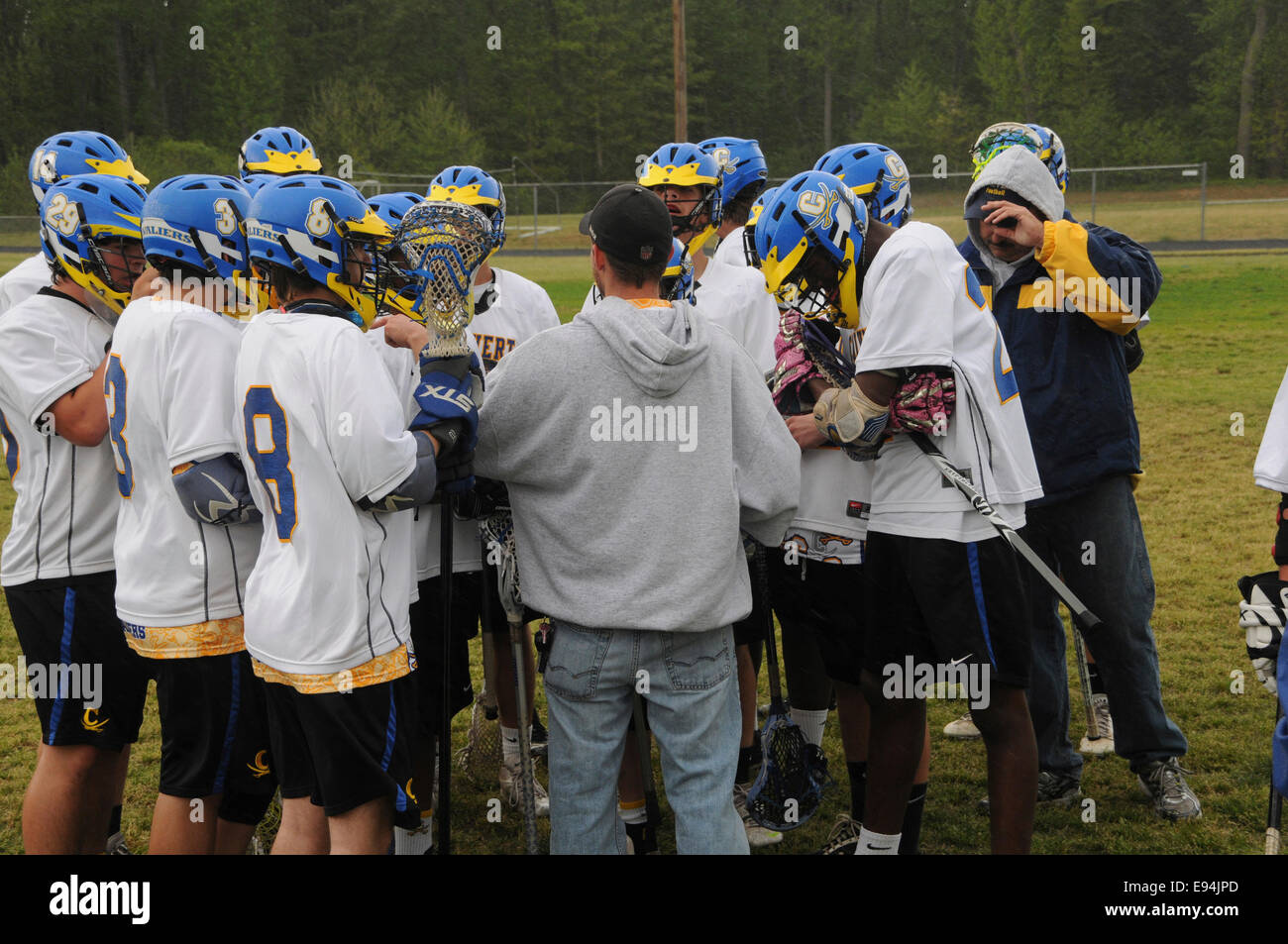 Coach talking to his team of lacrosse players Stock Photo