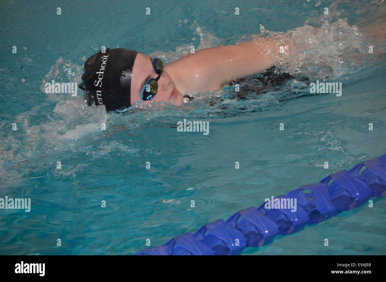 Young girl swimming in a swim meet Stock Photo