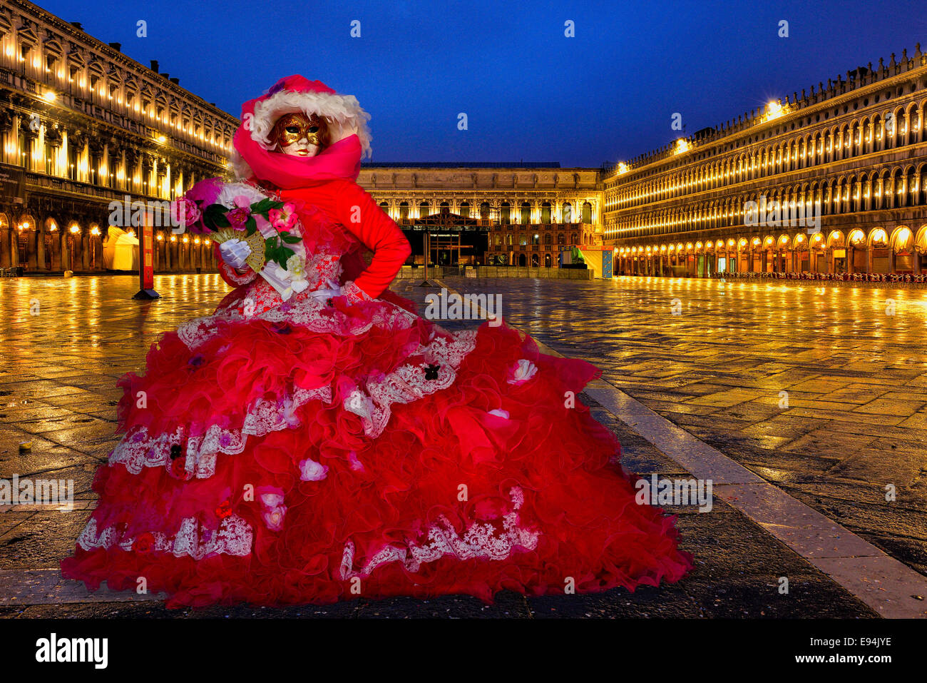 Venice Carnivale,  February 2014. A costumed Carnival model in an empty Piazza San Marco before sunrise. Stock Photo