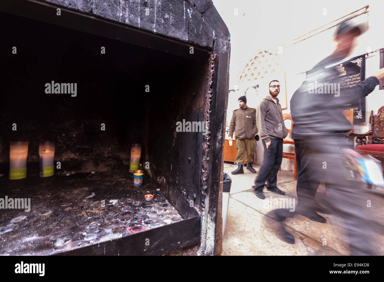 Hebron, Israel. Memorial candles (front) and Orthodox Jews (background) in the Cave of the Patriarchs (Machpela cave) Stock Photo