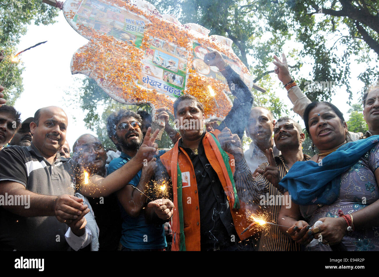 New Delhi. 19th Oct, 2014. Bharatiya Janata Party (BJP) supporters celebrate outside the BJP headquarters as Haryana and Maharashtra states assembly elections results come out in New Delhi, India on Oct.19, 2014. India's ruling BJP has won control of the country's financial capital Mumbai through a legislative election in the state of Maharashtra, while also grasping the northern state of Haryana from the Congress, said vote counting results Sunday. Credit:  Partha Sarkar/Xinhua/Alamy Live News Stock Photo