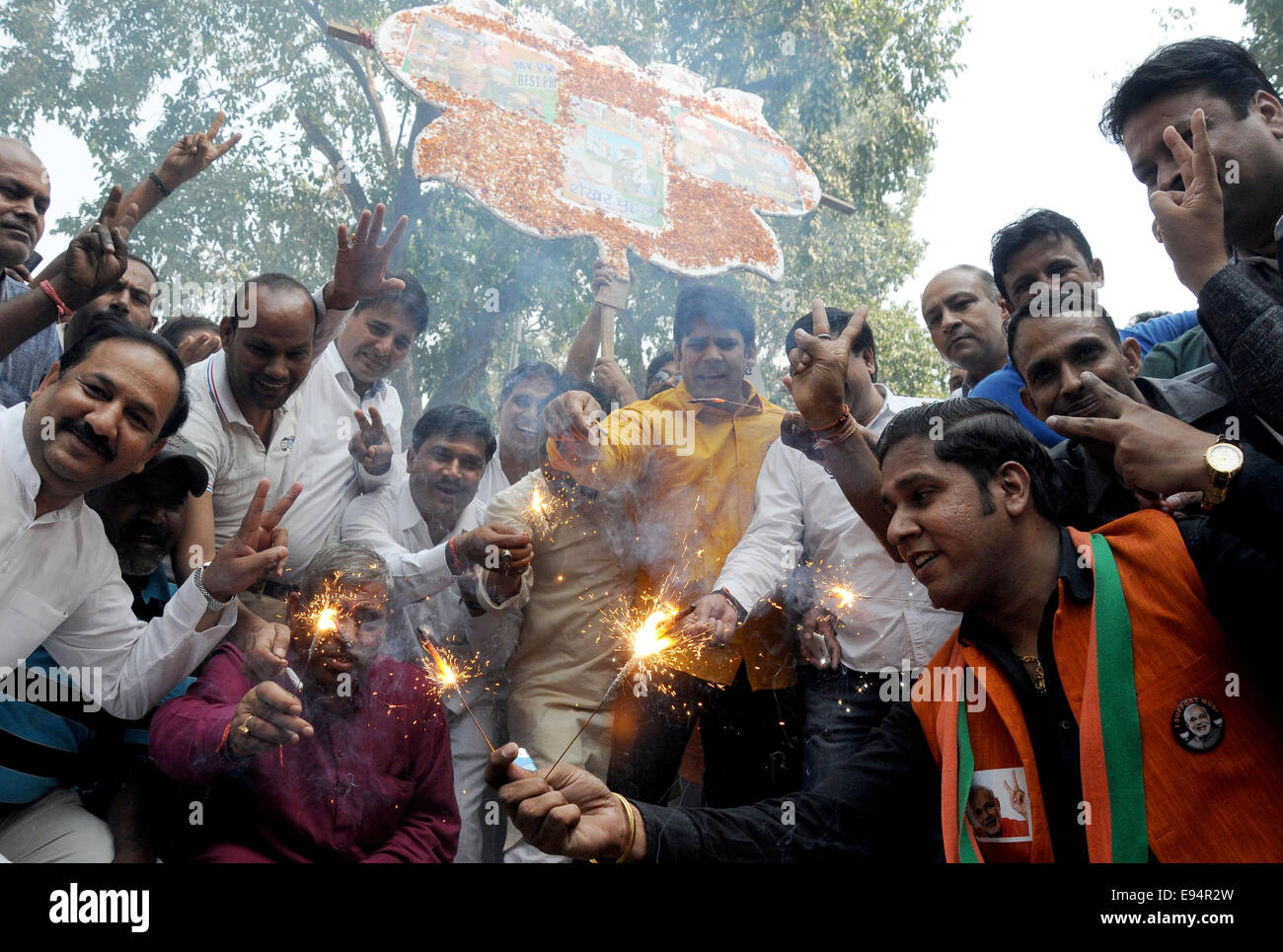New Delhi. 19th Oct, 2014. Bharatiya Janata Party (BJP) supporters celebrate outside the BJP headquarters as Haryana and Maharashtra states assembly elections results come out in New Delhi, India on Oct.19, 2014. India's ruling BJP has won control of the country's financial capital Mumbai through a legislative election in the state of Maharashtra, while also grasping the northern state of Haryana from the Congress, said vote counting results Sunday. Credit:  Partha Sarkar/Xinhua/Alamy Live News Stock Photo