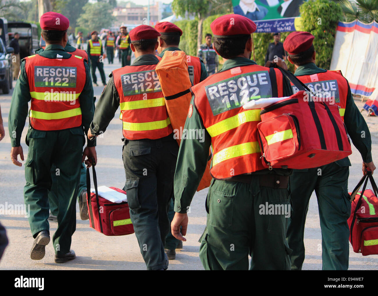 Lahore, Pakistan. 19th Oct, 2014. Pakistan's Rescue team carry the first aid items during an anti government rally in Lahore. Former cricket hero Imran Khan and cleric Tahir-ul-Qadri launched separate protests on August 14, and thousands of their supporters set up camp in front of the parliament, calling for Prime Minister Nawaz Sharif to step down. The two leaders were holding separate talks with government representatives to end the standoff, but suspended the process after the arrests of their activists. Credit:  Rana Sajid Hussain/Pacific Press/Alamy Live News Stock Photo