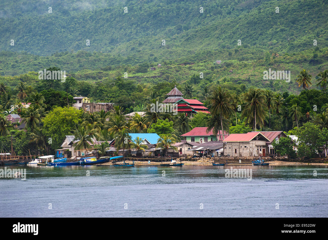 Boats and village after tropical rainfall, Tomea Island, Sulawesi, Indonesia Stock Photo