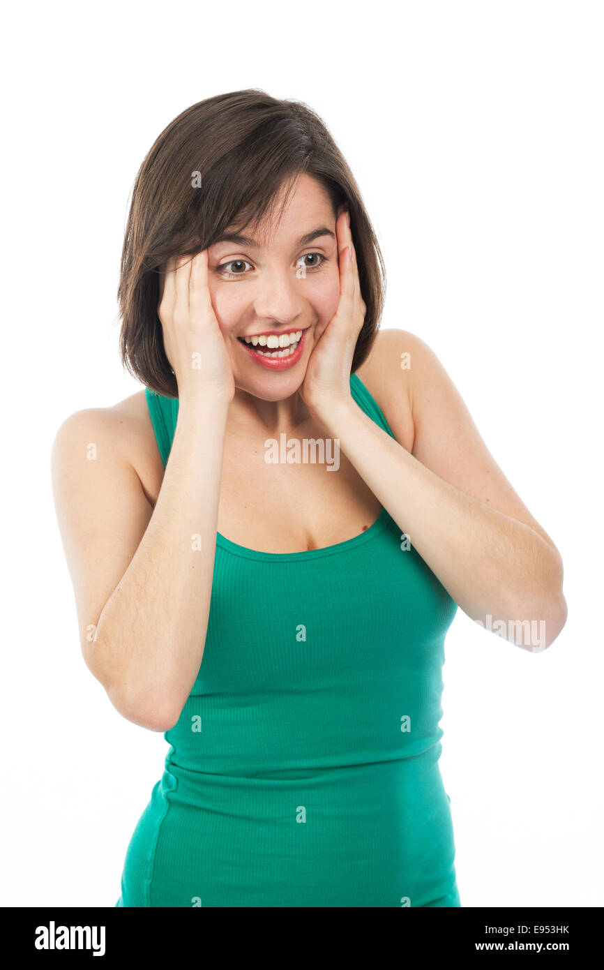 Young woman amazed and holding her face with her hands, isolated on white Stock Photo