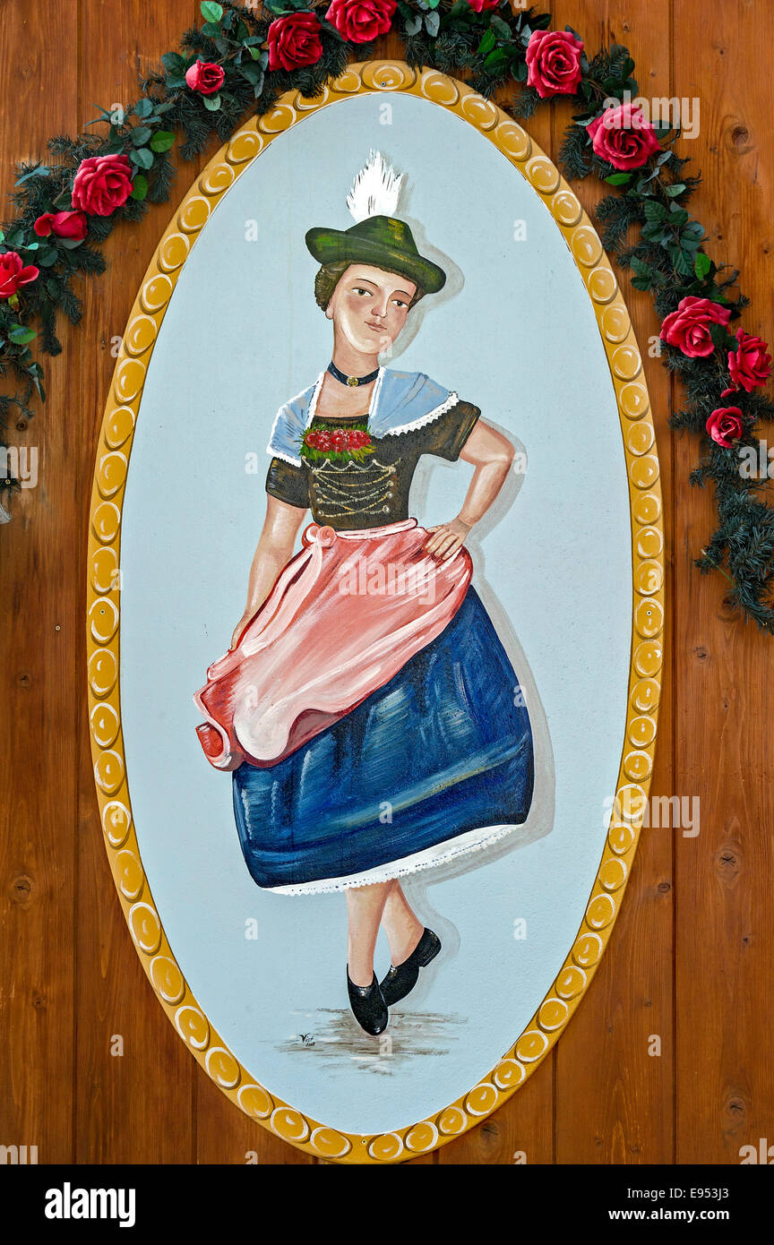 Woman dancing the Schuhplattler in Bavarian dress, painted on a wooden board, Echelsbach, Upper Bavaria, Bavaria, Germany Stock Photo