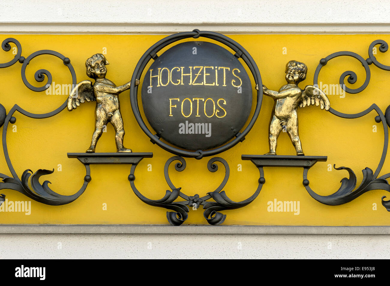 Wrought iron sign for 'Hochzeitsfotos' or wedding photos with cherubs on a photo shop, Murnau, Upper Bavaria, Bavaria, Germany Stock Photo