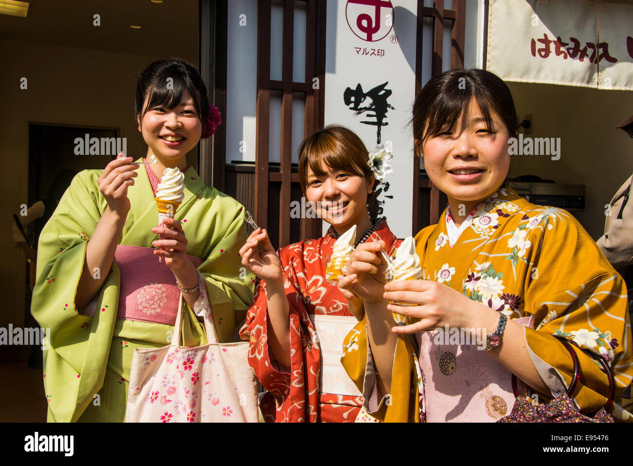 Traditionally dressed girls eating icecream, Kyoto, Japan Stock Photo