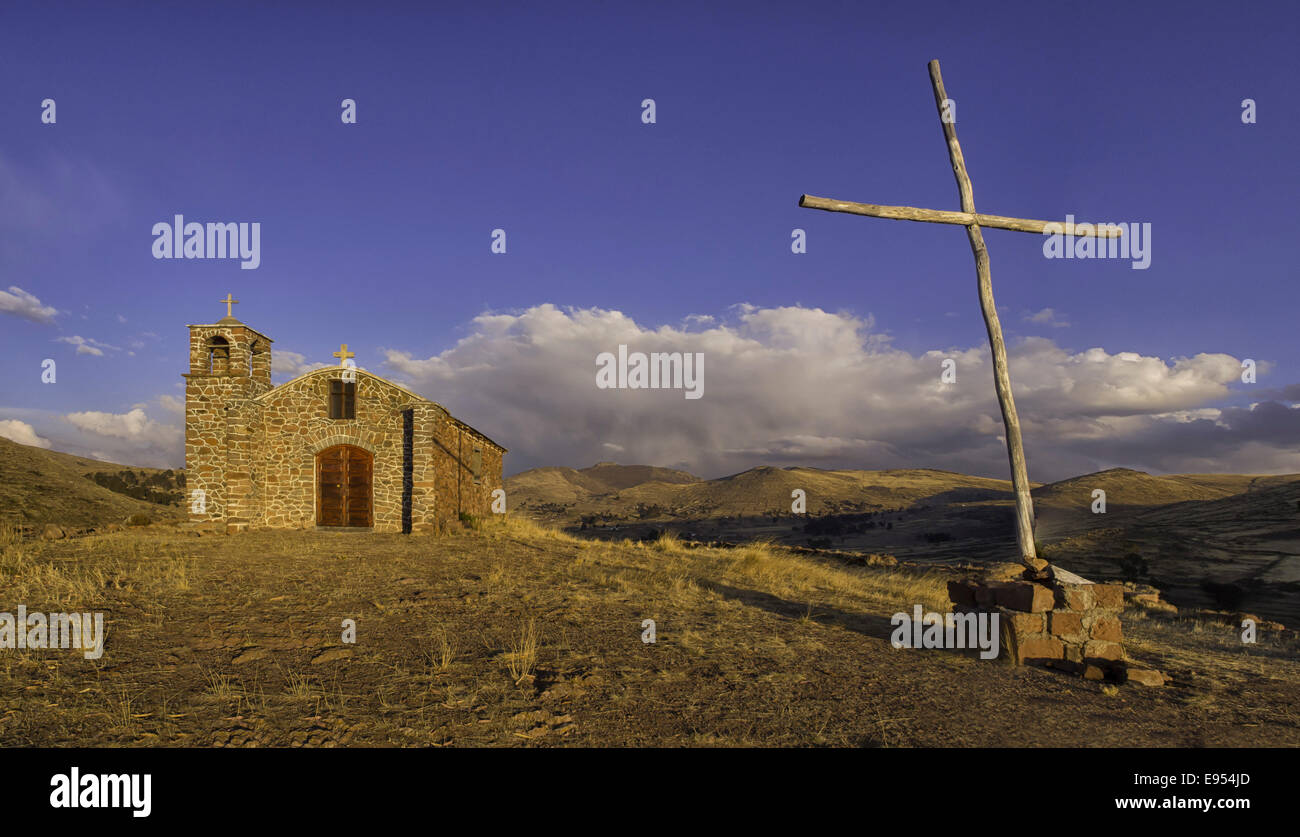 Small church and cross in the backcountry, Bolivian plateau Altiplano, Santiago De Huata, La Paz, Bolivia Stock Photo