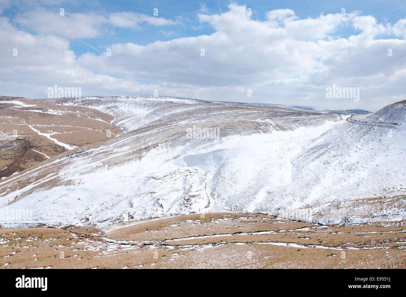 Large snowdrifts in a moorland landscape near Hayfield in the High Peak, Derbyshire. Stock Photo