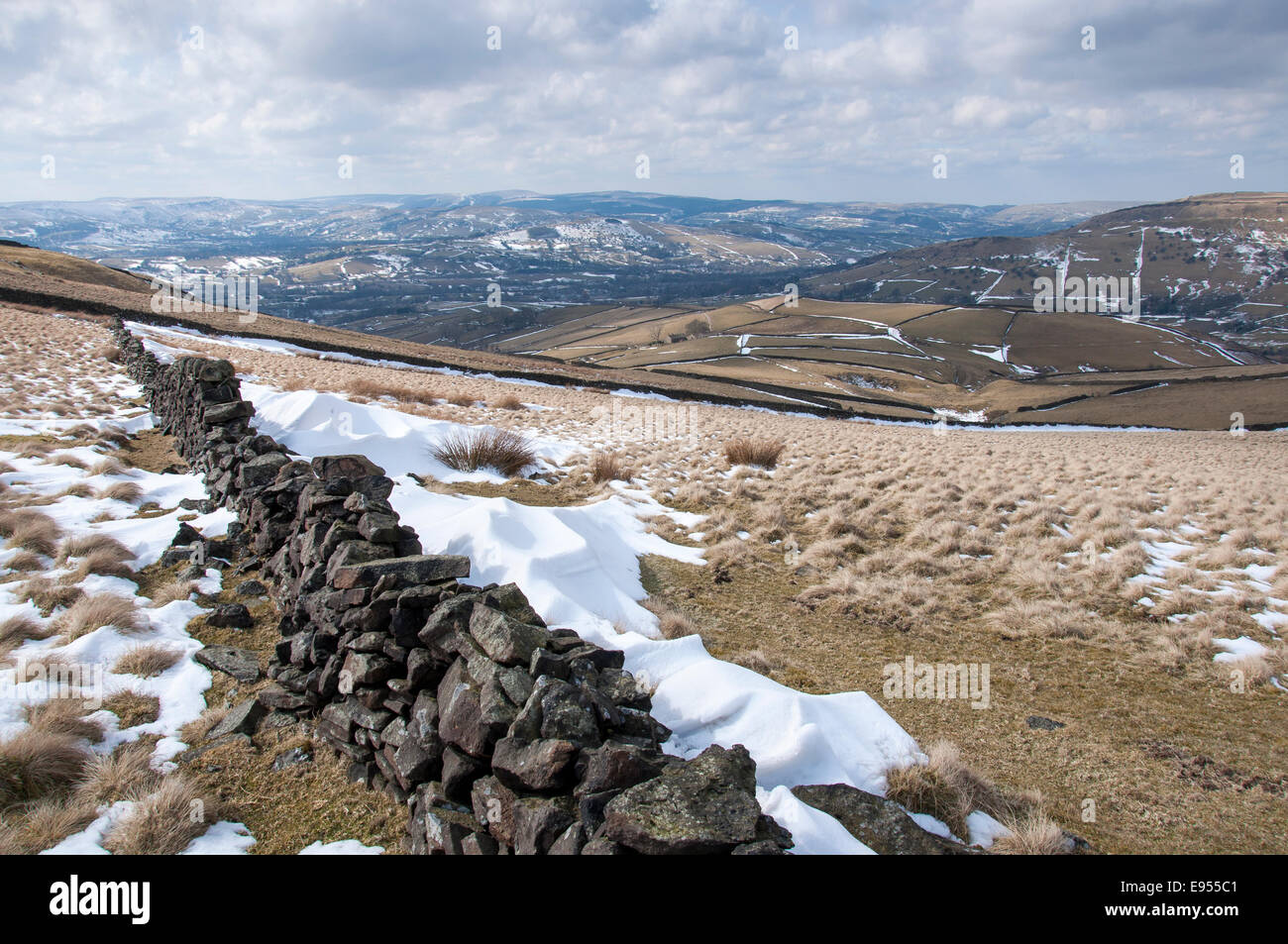 Stone wall and snowdrift in the High Peak, Derbyshire in late winter. Stock Photo