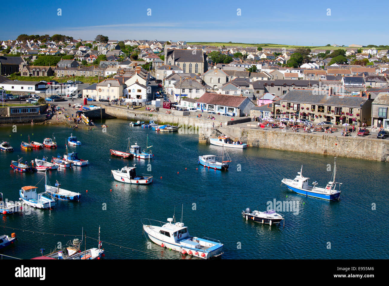 Porthleven harbour with small fishing and pleasure boats, the quay and town is spread behind, Cornwall, England, UK. Stock Photo