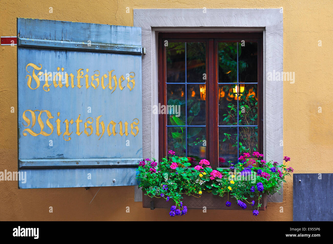 Window with shutters and flower-box of a Franconian inn, Rothenburg ob der Tauber, Middle Franconia, Bavaria, Germany Stock Photo