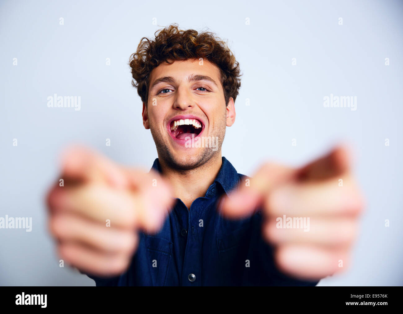 Portrait of a laughing man pointing at you Stock Photo