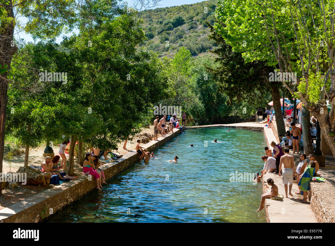 Portugal, the Algarve, people swimming in summer in a swimming pool in the river at Alte Stock Photo