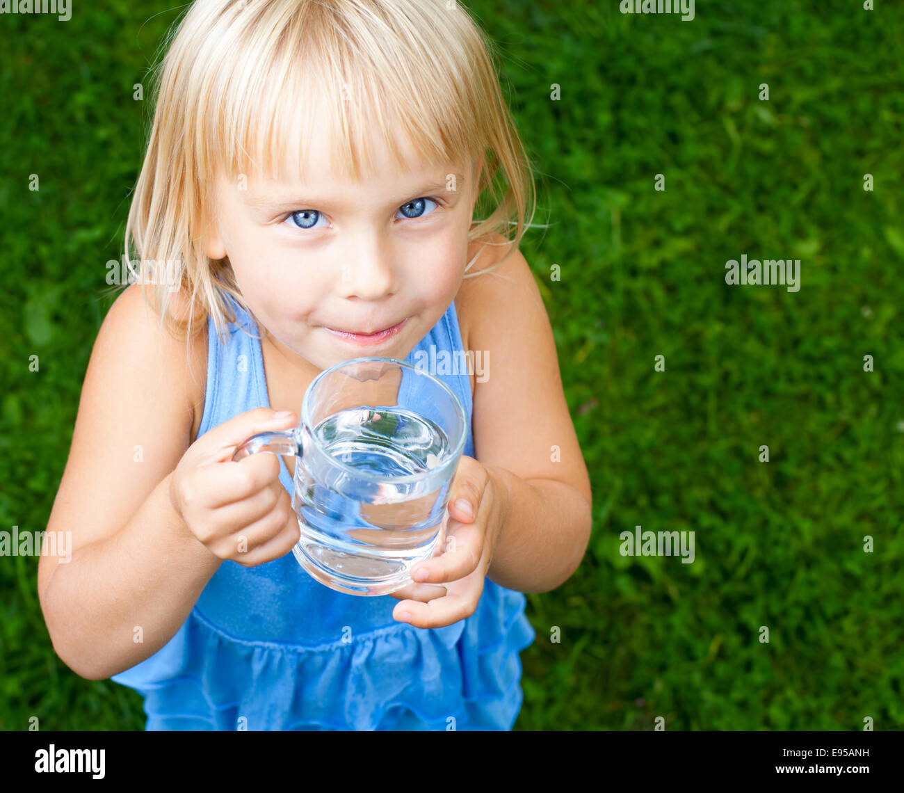 Little girl holding glass of water outdoors Stock Photo - Alamy