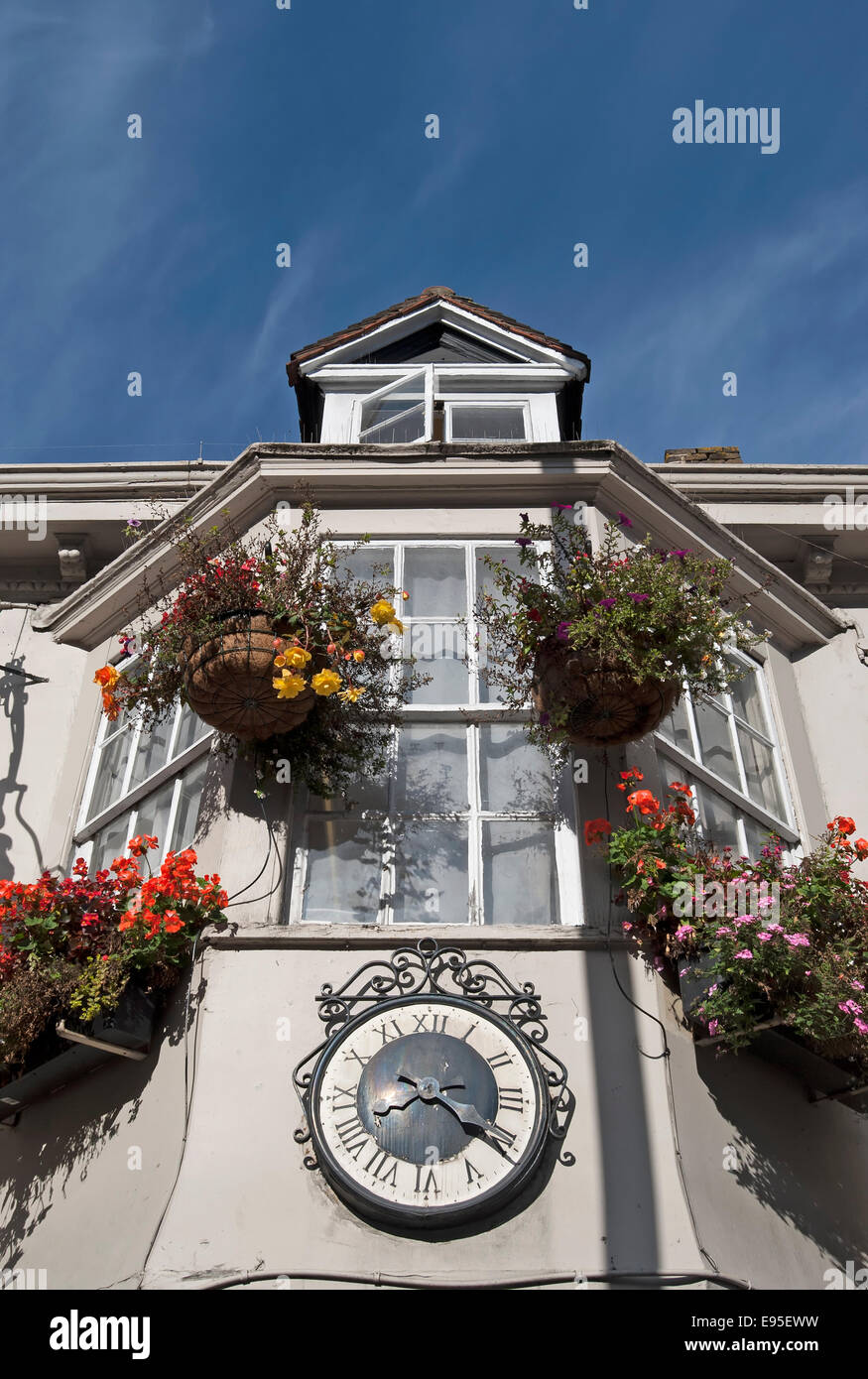 exterior, with hanging baskets and roman numeral clockface, of the george public house, twickenham, middlesex, england Stock Photo