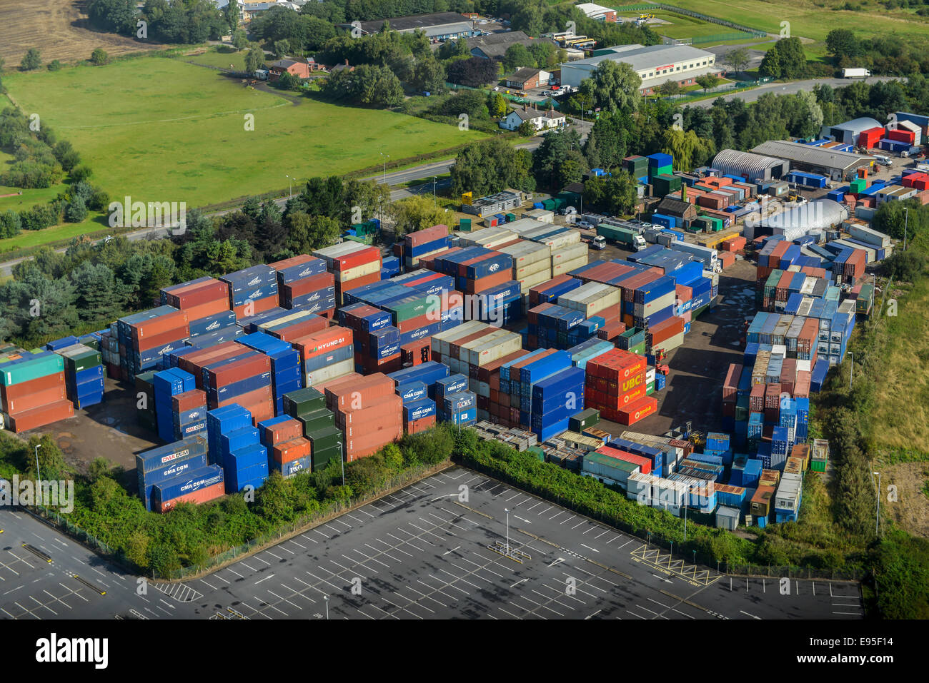 An aerial view of a light industrial unit with transport containers stacked up. Stock Photo