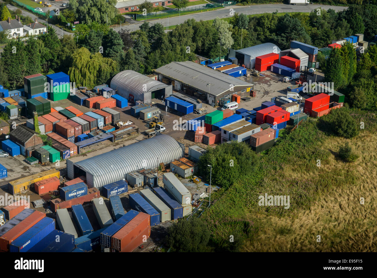 An aerial view of a light industrial unit with transport containers stacked up. Stock Photo