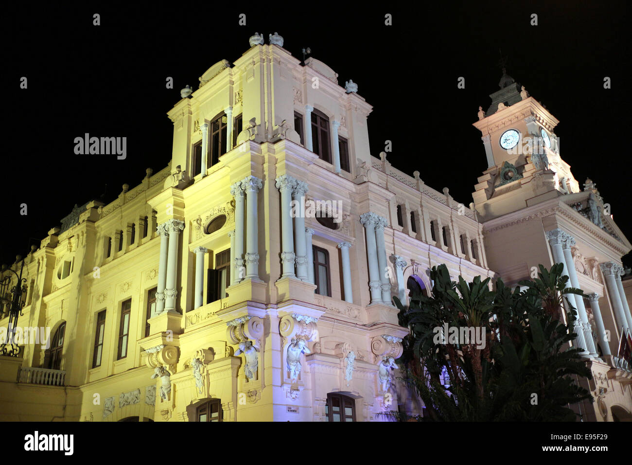Malaga city council building and silhouette of palm trees City of