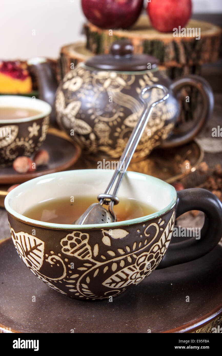 White Tea Pot And Cup With Tea Strainer On Wooden Table, Relaxing With Hot  Tea During Tea Break. Stock Photo, Picture and Royalty Free Image. Image  84607717.