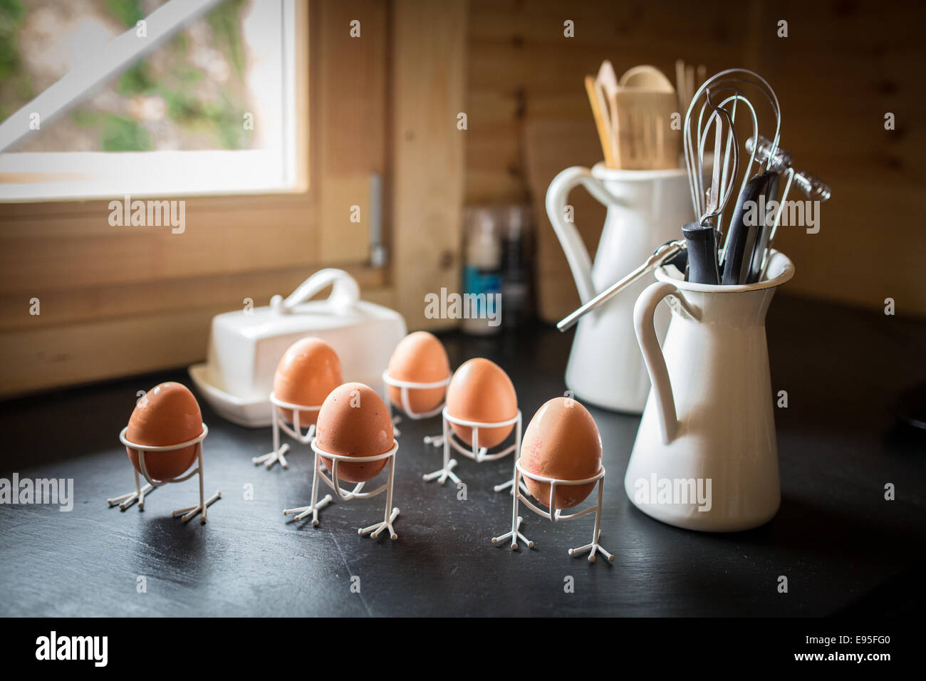 Eggs and kitchen utensils on kitchen worktop Stock Photo