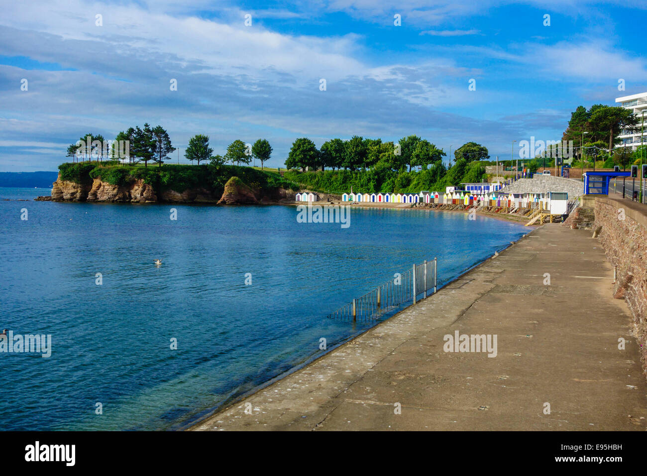 Beach huts tucked away in a quiet corner of Torquay seafront Stock Photo