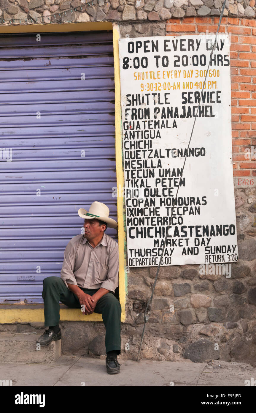 Man sitting outside a shop, Panajachel, Guatemala Stock Photo