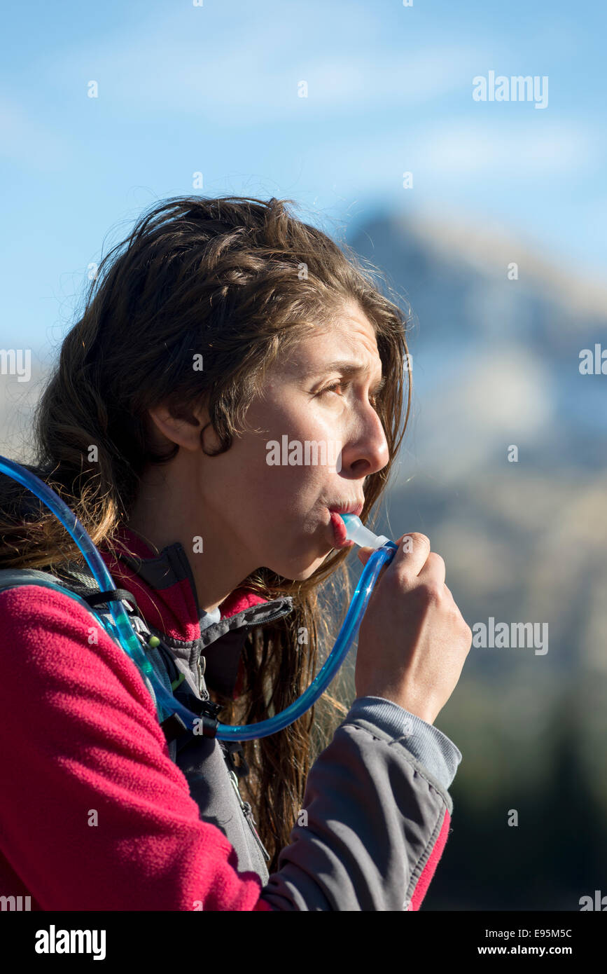 Hiker drinking from a hydration tube. Stock Photo