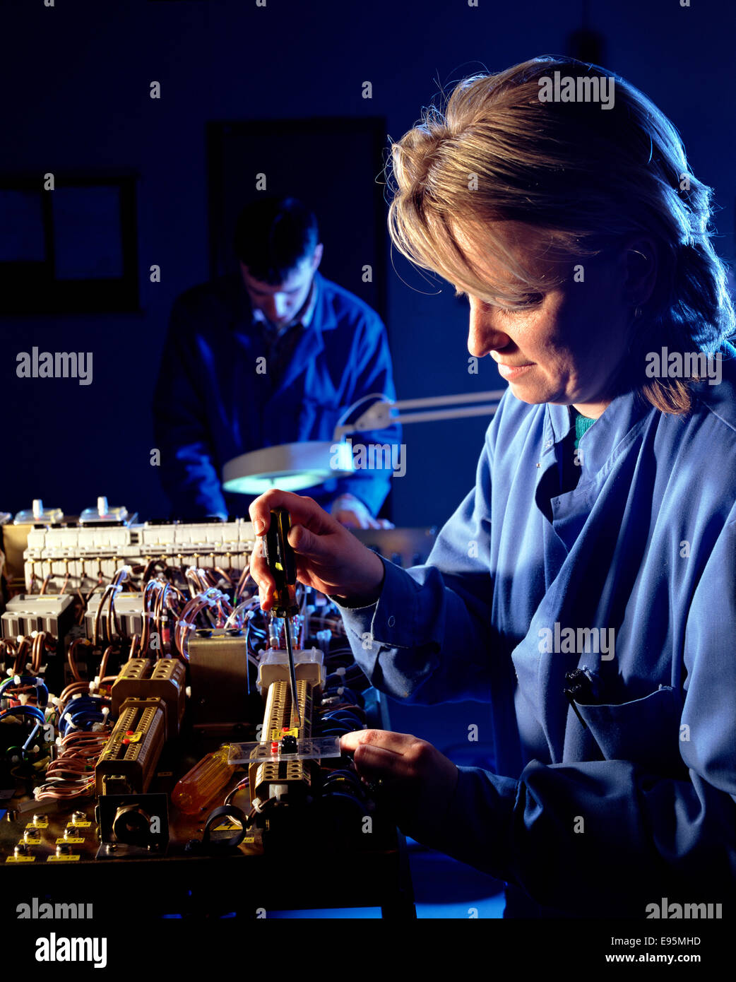 Woman electronics factory worker hi-res stock photography and images ...