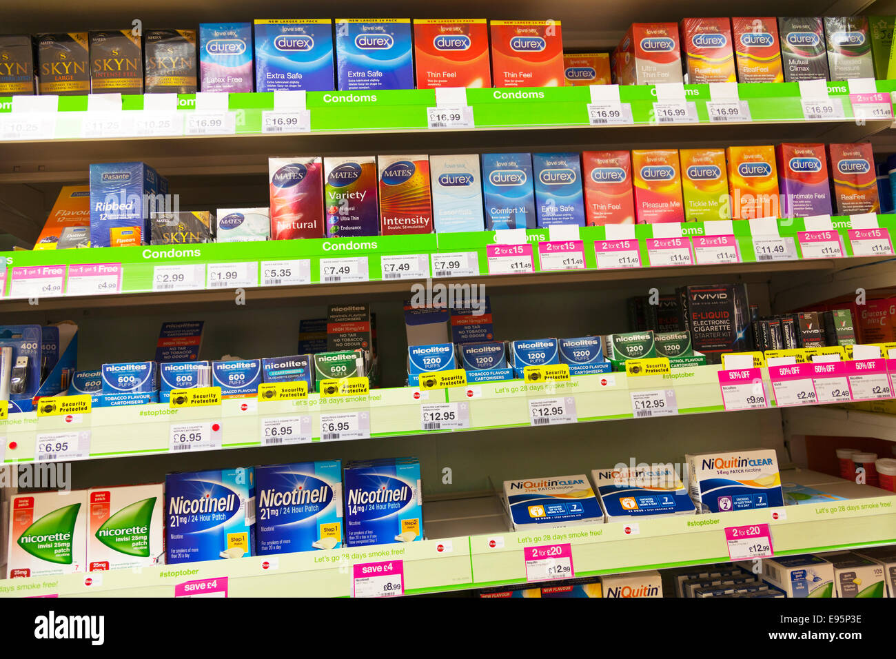 durex condoms nicotinell tobacco replacement product products on shelf at chemist Chemists shop store inside display Stock Photo