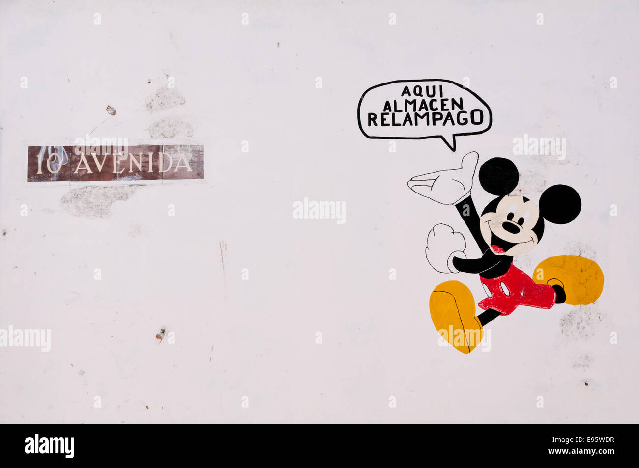 Mickey mouse painted sign on a wall, advertising the way to a lighting store, Quetzaltenango, Guatemala Stock Photo